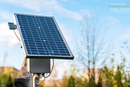 Solar security lamps mounted on a wall lighting up a dark outdoor area at night.