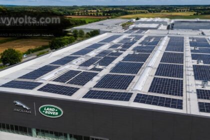 Jaguar Land Rover rooftop solar installation featuring large photovoltaic solar panels covering a manufacturing facility roof, showcasing renewable energy, clean electricity generation, and sustainable automotive production.