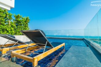 Solar panels installed on a rooftop powering a residential pool heating with solar.